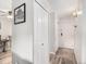 Hallway featuring closet space, neutral walls, updated flooring, and a view into other living spaces at 6930 E Girard Ave # 304, Denver, CO 80224