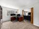 Functional home office space featuring a desk setup, natural light, and barn door access to living room at 6930 E Girard Ave # 304, Denver, CO 80224