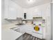 Clean kitchen featuring all-white cabinets, modern appliances, and updated flooring at 6930 E Girard Ave # 304, Denver, CO 80224