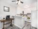 Bright kitchen featuring white cabinets, a breakfast bar, modern appliances, and updated flooring at 6930 E Girard Ave # 304, Denver, CO 80224