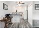 Efficient kitchen with white cabinets, modern appliances, breakfast bar, and stylish flooring at 6930 E Girard Ave # 304, Denver, CO 80224
