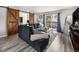 Inviting living room featuring a sectional sofa, sliding barn doors, and access to a private balcony at 6930 E Girard Ave # 304, Denver, CO 80224