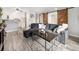 Comfortable living room featuring modern decor, a sectional sofa, and an open layout to the kitchen at 6930 E Girard Ave # 304, Denver, CO 80224