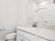 Bathroom with quartz countertops, white cabinets, and modern fixtures at 487 Interlocken Blvd # 410, Broomfield, CO 80021