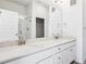 Elegant bathroom with a dual-sink vanity, quartz counters, and glass-enclosed shower, exuding modern comfort at 487 Interlocken Blvd # 410, Broomfield, CO 80021