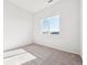 Bright bedroom featuring soft carpet, neutral paint, and large window at 487 Interlocken Blvd # 410, Broomfield, CO 80021