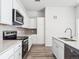 Kitchen with quartz countertops, white cabinetry, stainless steel appliances and gray subway tile backsplash at 487 Interlocken Blvd # 410, Broomfield, CO 80021