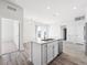 Open kitchen featuring an island with a stainless steel sink, dishwasher, and quartz countertop at 487 Interlocken Blvd # 410, Broomfield, CO 80021