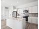 Modern kitchen with stainless steel appliances, white cabinetry and quartz countertops at 487 Interlocken Blvd # 410, Broomfield, CO 80021
