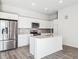 A modern kitchen is complete with stainless steel appliances, white cabinets, and an island at 487 Interlocken Blvd # 410, Broomfield, CO 80021