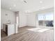 Open living room, with modern flooring, attached kitchen island, and balcony access at 487 Interlocken Blvd # 410, Broomfield, CO 80021