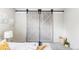 Bright bedroom featuring attractive sliding barn doors and modern neutral decor at 5300 E Cherry Creek South Dr # 620, Denver, CO 80246