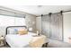 Cozy bedroom showcasing sliding barn doors, soft natural light, and neutral tones at 5300 E Cherry Creek South Dr # 620, Denver, CO 80246