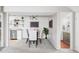 Stylish dining room area adjacent to kitchen with modern decor and a glimpse into the adjacent bathroom at 5300 E Cherry Creek South Dr # 620, Denver, CO 80246