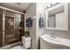 Cozy bathroom with brown-tiled shower, white vanity, and neutral wall color at 8337 S Upham Way # 103, Littleton, CO 80128