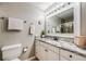 Bright bathroom with granite countertop, white vanity, and glass shower door at 8337 S Upham Way # 103, Littleton, CO 80128
