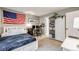 Bright bedroom offering a comfortable bed, desk, and built in shelving at 8337 S Upham Way # 103, Littleton, CO 80128