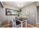 Cozy dining room with wooden table and chairs, complemented by modern wall art and elegant lighting at 8337 S Upham Way # 103, Littleton, CO 80128