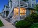 Townhome exterior with stairs leading to a cozy porch with string lights at 8337 S Upham Way # 103, Littleton, CO 80128