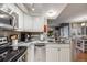 Bright kitchen with granite countertops, stainless steel appliances, and white cabinets at 8337 S Upham Way # 103, Littleton, CO 80128