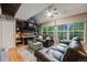 Cozy living room with a brick fireplace, vaulted ceilings, large windows, and comfortable seating at 8337 S Upham Way # 103, Littleton, CO 80128