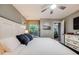 Large main bedroom with natural light, ceiling fan, and ensuite bathroom entrance at 8337 S Upham Way # 103, Littleton, CO 80128