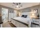 Spacious main bedroom with ceiling fan, white furniture, and ensuite bathroom at 8337 S Upham Way # 103, Littleton, CO 80128