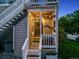 Inviting porch with unit number, hanging flower basket, and string lights at 8337 S Upham Way # 103, Littleton, CO 80128