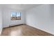 Bright, minimalist bedroom with hardwood floors and a large window at 1008 N Corona St # 405, Denver, CO 80218