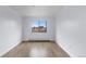 A simple bedroom with wood flooring and a window overlooking an urban view at 1008 N Corona St # 405, Denver, CO 80218