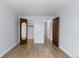 A light-filled bedroom features stylish wood-look floors and multiple doorways at 1008 N Corona St # 405, Denver, CO 80218