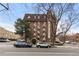 A multi-level brick condo building with mature trees and parking in a lively urban neighborhood at 1008 N Corona St # 405, Denver, CO 80218