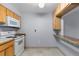 A kitchen with white appliances and light wood cabinets with access to a breakfast bar at 1008 N Corona St # 405, Denver, CO 80218