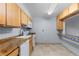 Well-lit kitchen with tile floors, light wood cabinets, and a breakfast bar area at 1008 N Corona St # 405, Denver, CO 80218