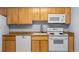 This well-lit kitchen offers ample counter space with matching white appliances at 1008 N Corona St # 405, Denver, CO 80218