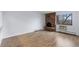 Spacious living room with hardwood floors and a charming brick fireplace, perfect for cozy evenings at 1008 N Corona St # 405, Denver, CO 80218