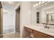Clean bathroom with a single sink vanity and a large mirror at 10490 W Jewell Ave # D, Lakewood, CO 80232
