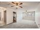 Upstairs bedroom with carpet, ceiling fan, and access to a hallway at 10490 W Jewell Ave # D, Lakewood, CO 80232