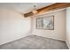 Small bedroom with carpeted floor, window with blinds, and wood beam at 10490 W Jewell Ave # D, Lakewood, CO 80232