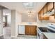 Simple kitchen with light wood cabinets, appliances, and vinyl flooring at 10490 W Jewell Ave # D, Lakewood, CO 80232
