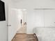 Bedroom with wood floor showing doorway and sliding closet door at 1748 Eagle St # B, Aurora, CO 80011