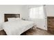 Bedroom featuring a bed, wood floor, a window with curtain and a drawer at 1748 Eagle St # B, Aurora, CO 80011