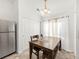 Bright dining area features a wooden table, tile floors, and stainless steel refrigerator at 1748 Eagle St # B, Aurora, CO 80011