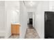 Hallway leading to bathroom and bedroom with patterned tile floor and white walls at 1748 Eagle St # B, Aurora, CO 80011
