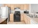 Kitchen featuring stainless steel appliances, light wood cabinets, and ample counter space at 1748 Eagle St # B, Aurora, CO 80011