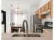 Charming kitchen view towards dining area with stainless steel refrigerator and ample natural light at 1748 Eagle St # B, Aurora, CO 80011