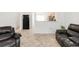 Open-concept living area featuring tile floors, neutral walls, and comfortable leather seating at 1748 Eagle St # B, Aurora, CO 80011