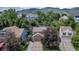 An aerial view of a tree-lined residential street with houses and mountain views at 573 Entrada Dr, Golden, CO 80401