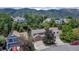 An aerial view of a residential neighborhood with tree-lined streets and mountain views at 573 Entrada Dr, Golden, CO 80401