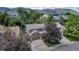 An elevated view of a cozy neighborhood street surrounded by verdant foliage and beautiful mountains at 573 Entrada Dr, Golden, CO 80401